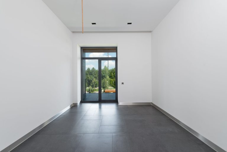 Large-format porcelain tile flooring in an empty Minnesota room
